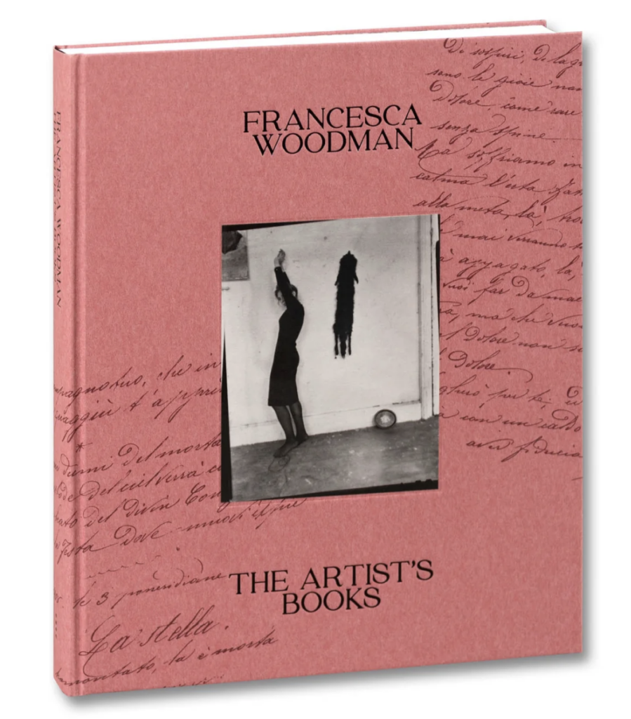 Pink book with a black and white photo by Francesca Woodman in the center