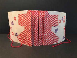 opened book shows its front and back covers with a kimono shape wrapping from cover to cover