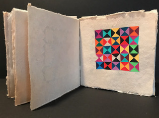 brightly colored quilt pattern on the right side of a page spread