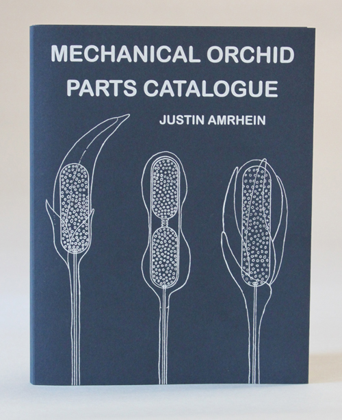 blue book with mechanical drawing of orchid parts