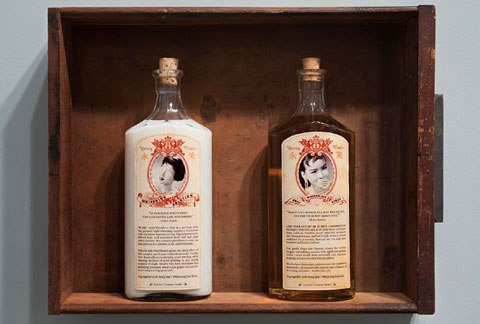 two bottles inside a empty wood drawer