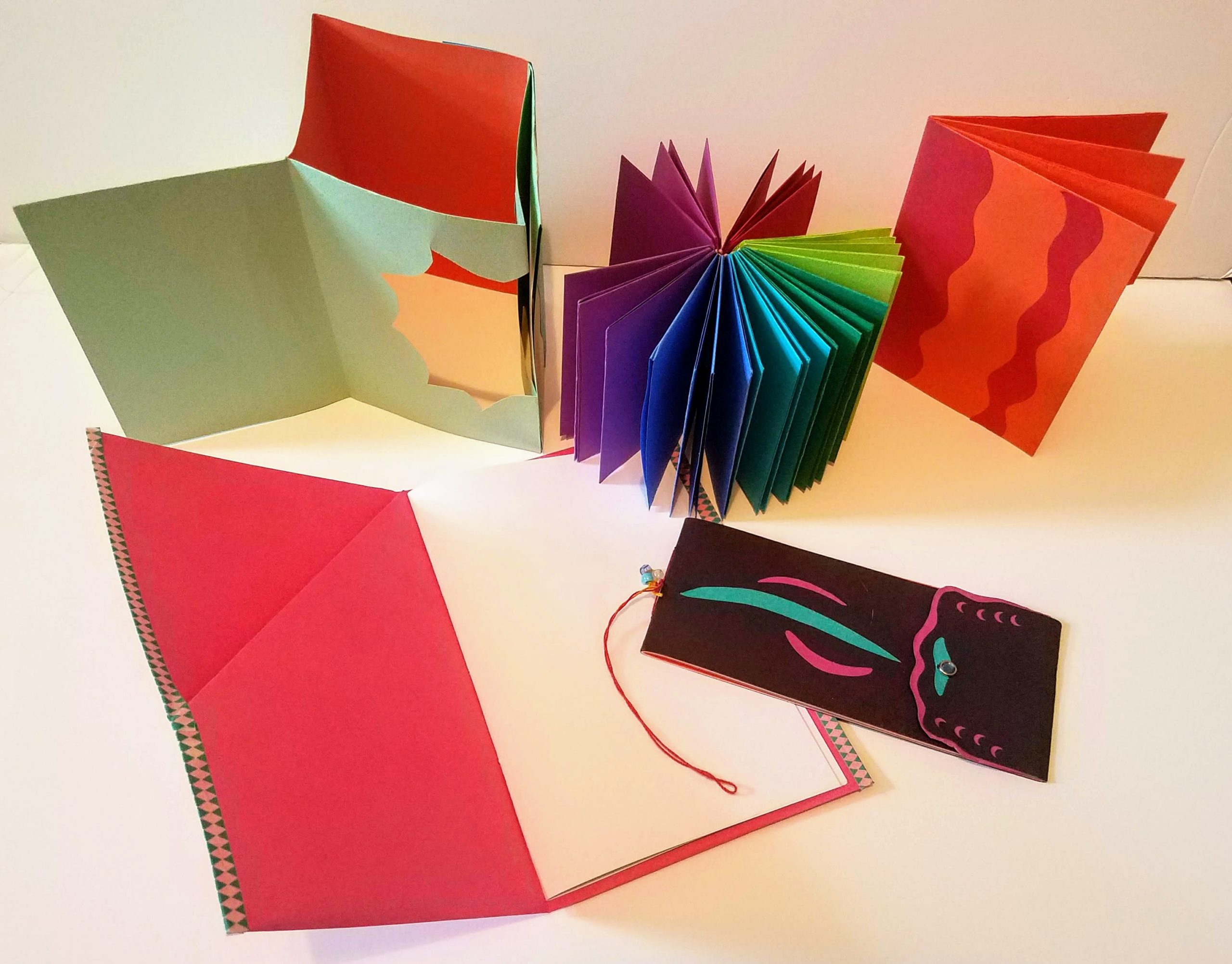 A series of five books made of colorful cardstock papers.
