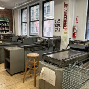 printshop filled with movable type and multiple vandercook letterpresses