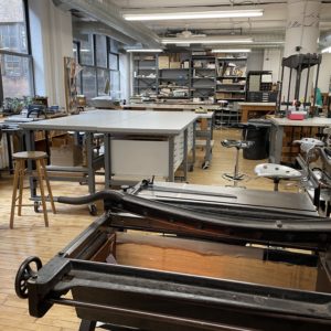 bookbindery with boardshears, tables, and many hand tools and presses