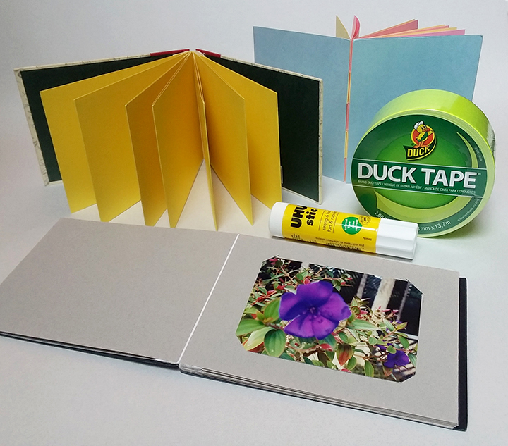 Depicted is Duck Tape, a UHU glue stick, and examples of books made in class.
