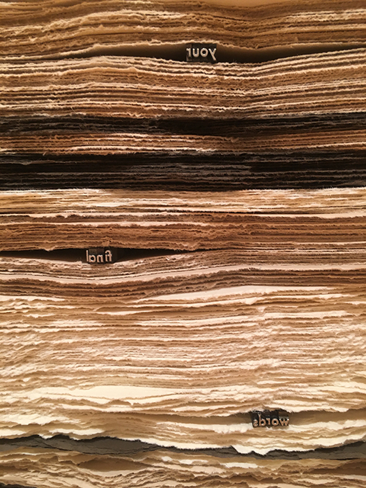 lead type embedded in a large stack of paper