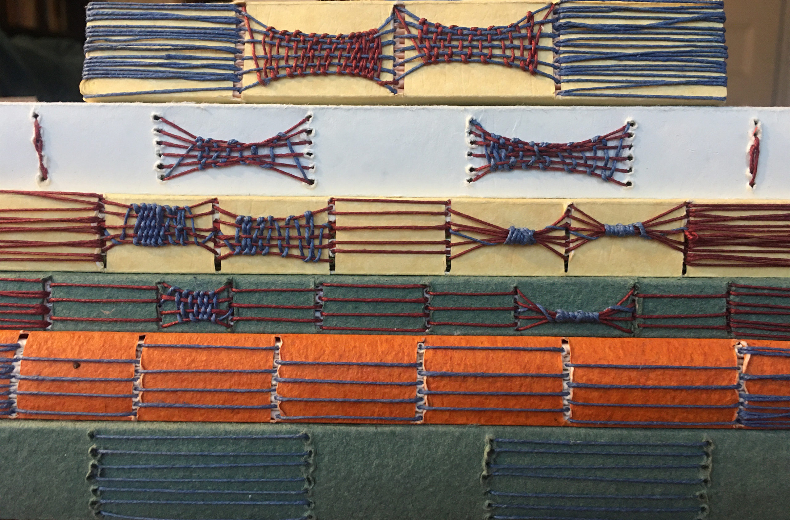 Examples of long & link stitch are stacked on top of one another. The photo shows the details of the spines.