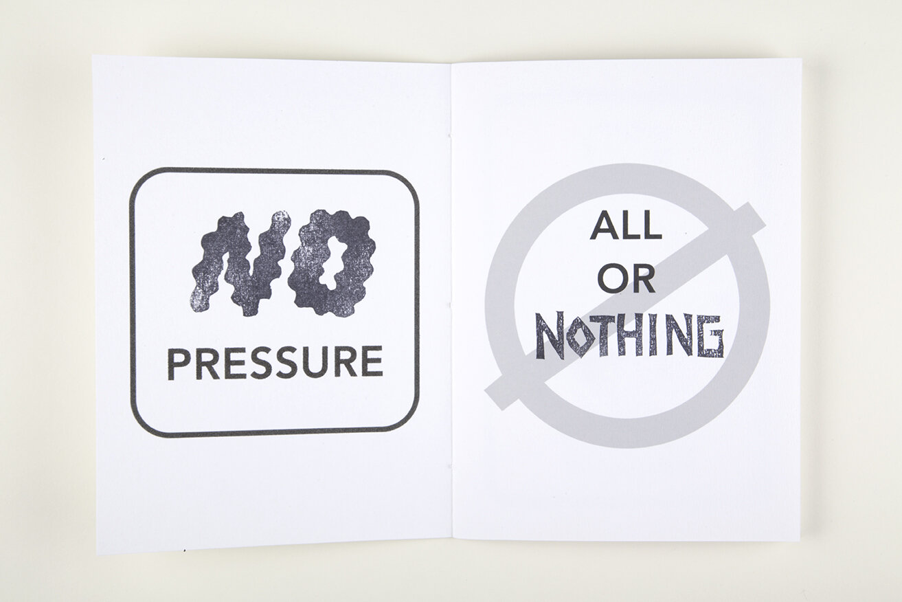 White open book over white background. Left page contains white box with black text in it reading "No Pressure". Right page contains grey prohibited sign with text "All or nothing" on it.