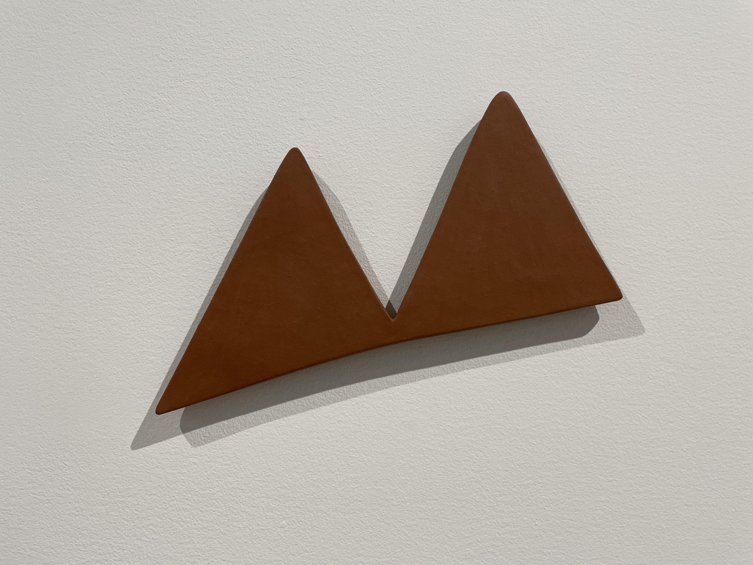 brown ceramic mountain-like shape about a quarter inch thick