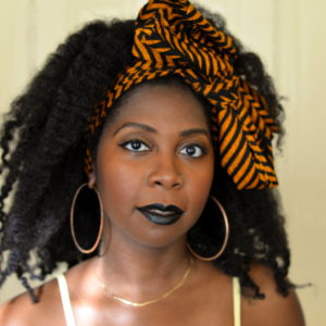 Dark skin woman with hair tied up with striped cloth