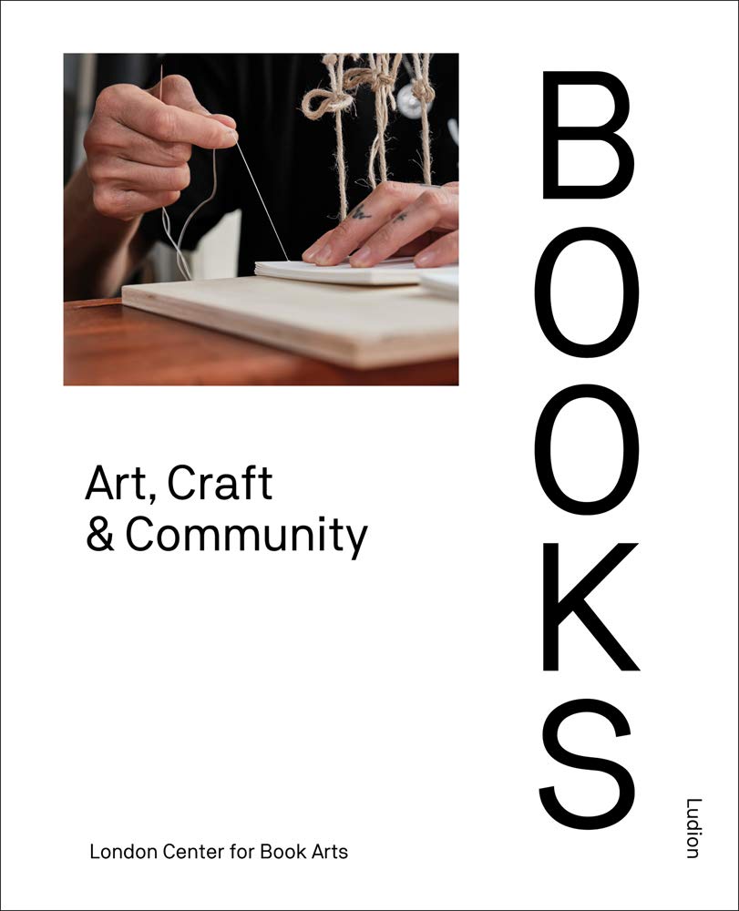 white book cover with close up image of hands sewing pages of book