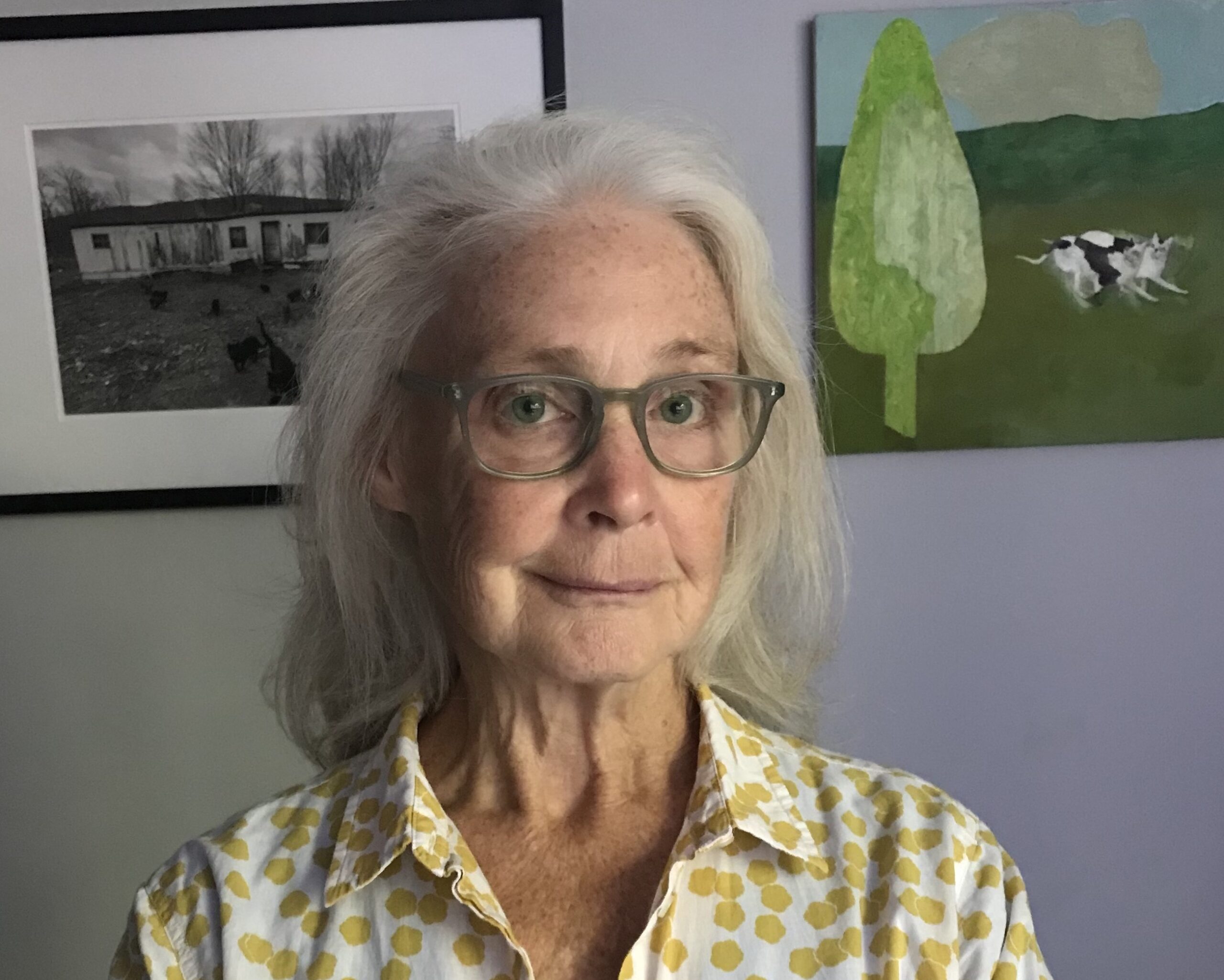 woman with sholder length gray hair and glasses