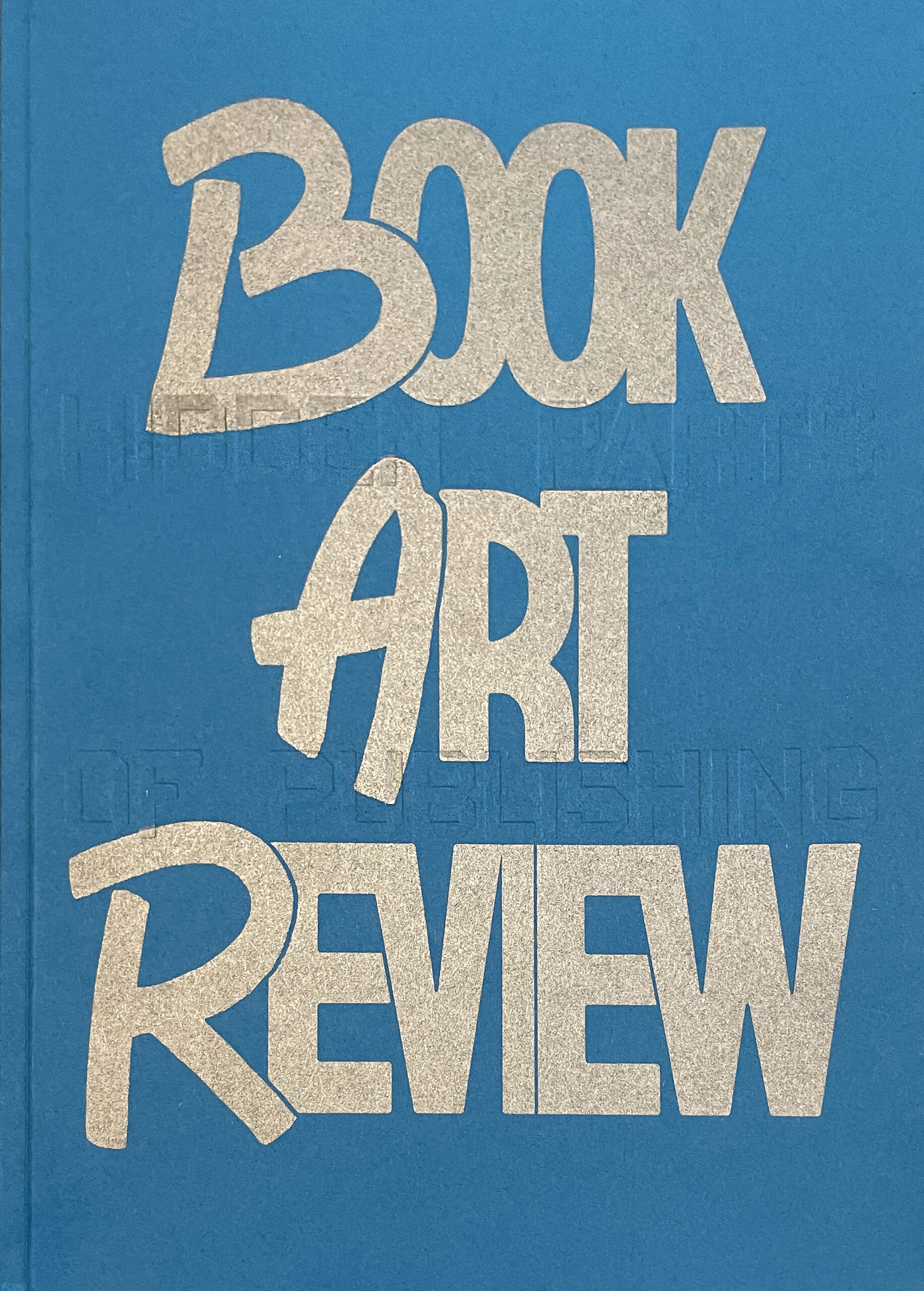 blue book cover with "Book Art Review" printed in silver and "the hidden parts of publishing" embossed
