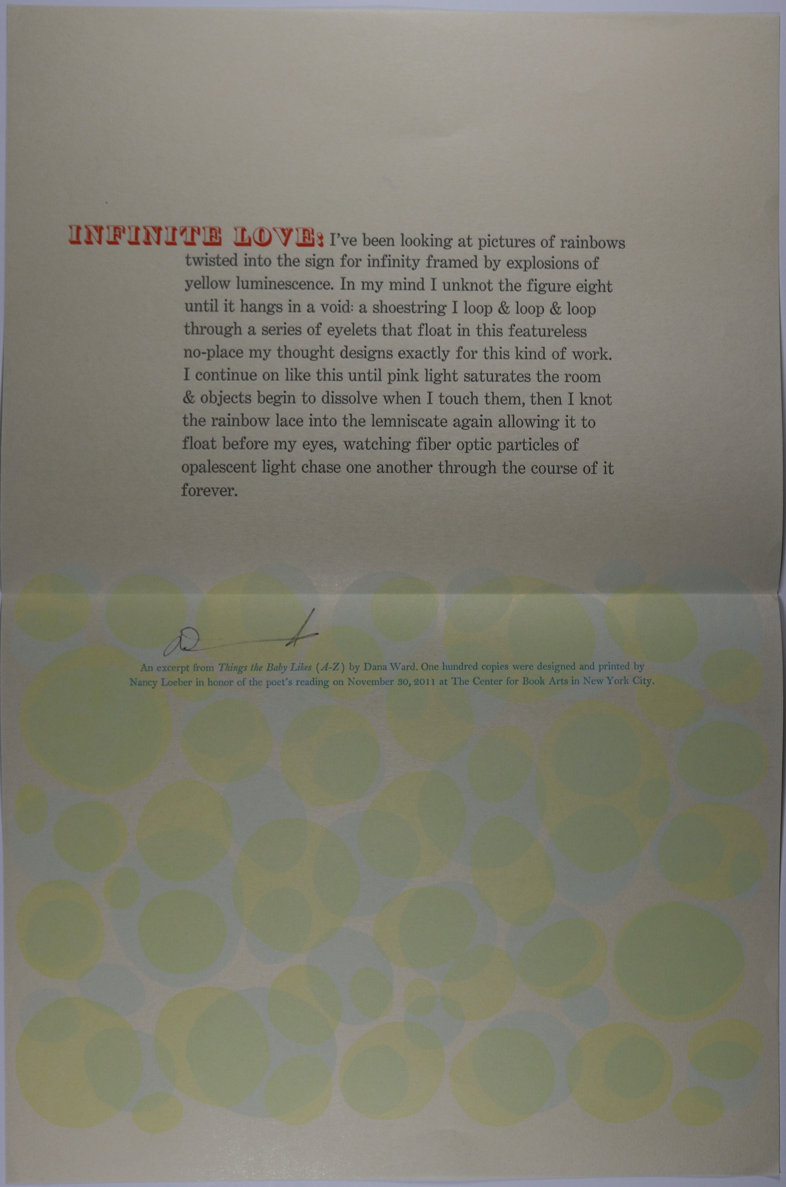 Parchment colored paper with the title in large red letters, text centered in paragraph form. Below is a print with light green and yellow circles.