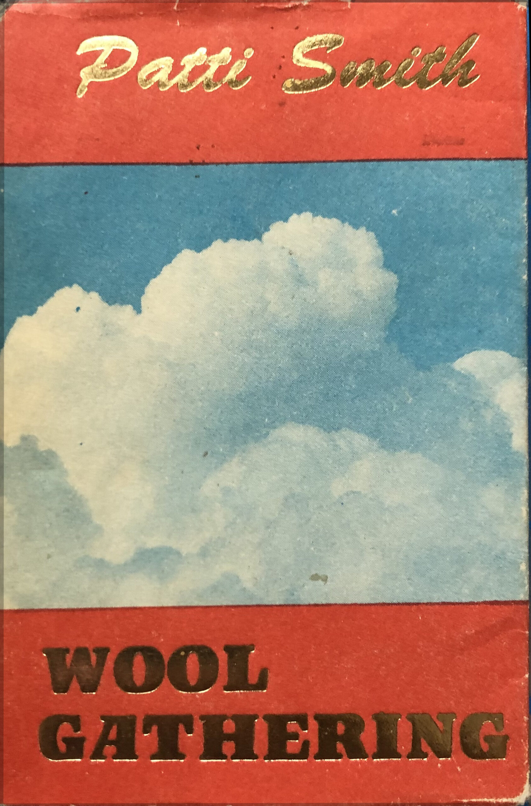 book cover with puffy white clouds and the title Wool Gathering in gold foil