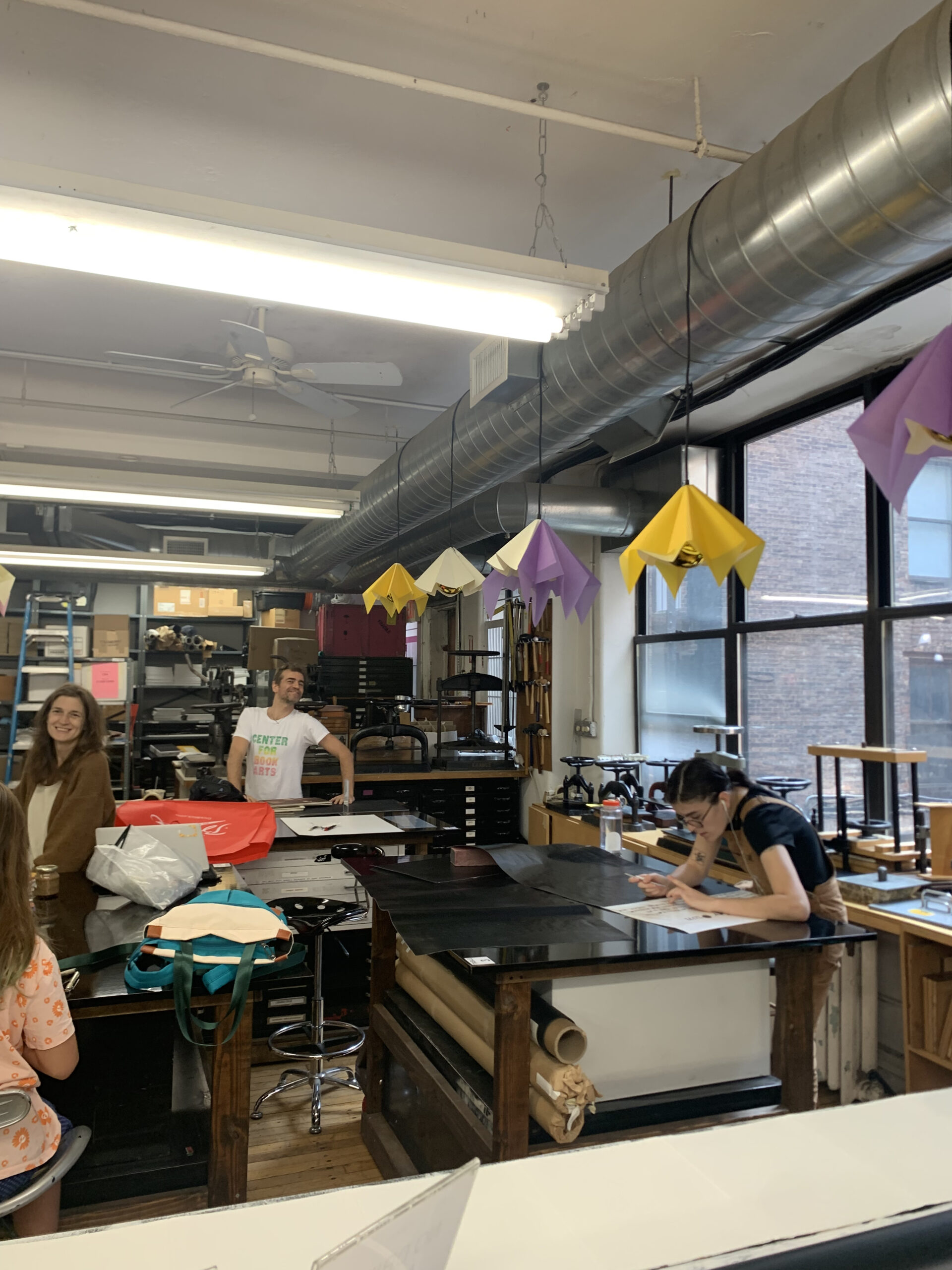 A group of people at work in the CBA bindery.