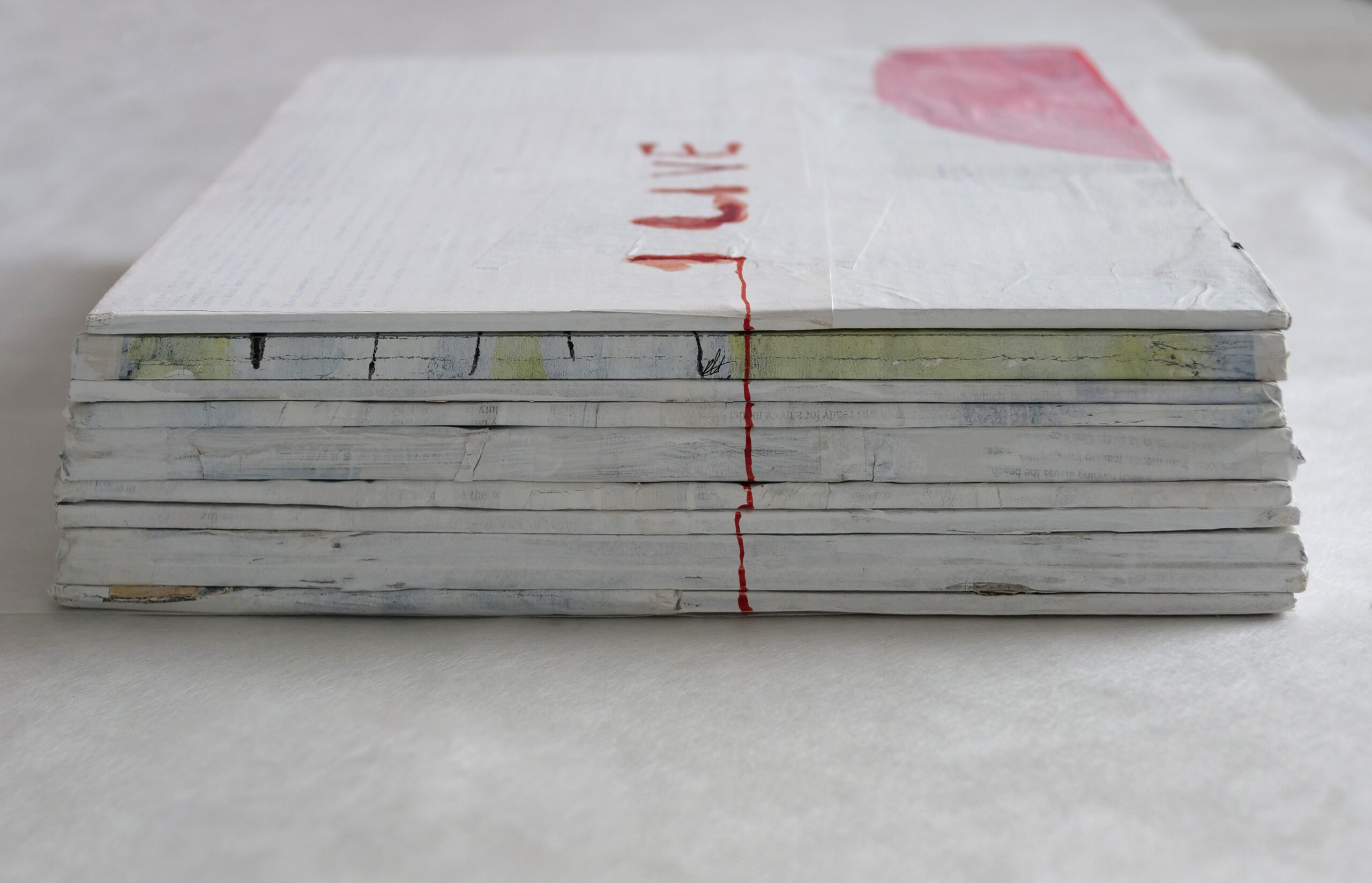 Sculptural artwork, possibly a book photographed with the spine in the foreground laying down